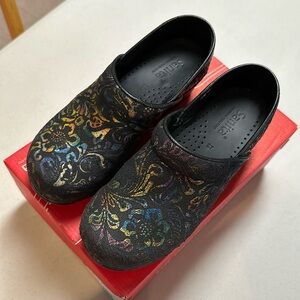 Sanita black embossed floral leather clogs